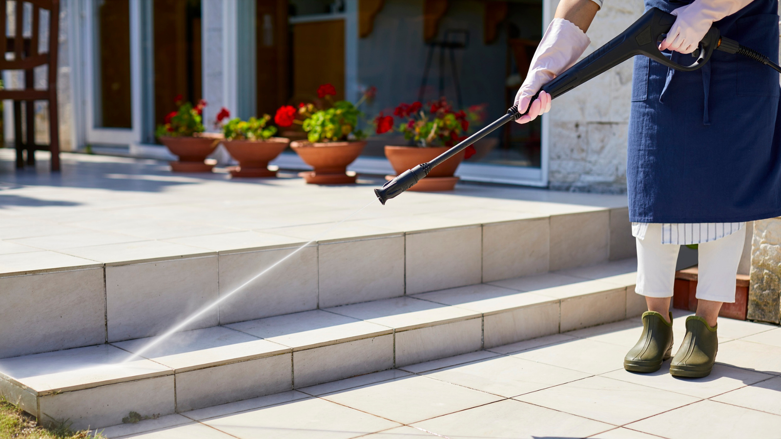a person cleaning the stairs with a pressure washer
